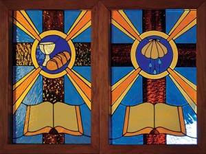 At the family's request, CLC Pastor David Reim made stained-glass   windows in memory of long-time Christian Day School Teacher LeRoy Greening (1930-2002).  The windows depict the Means of Grace—the Word of God, Baptism, and Lord's Supper. They adorn the chancel doors at  Redeemer Lutheran Church, Cheyenne,  Wyoming.