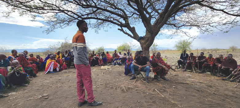 Pastor Solomon addresses the people at the new Maasai preaching station.