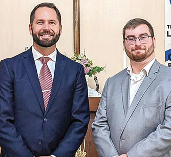 Pastor Luke Bernthal, left, with new teacher Isaac Schmitt