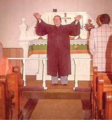 Pastor Leland L. Grams (1919-1997) bestowing the Aaronic Benediction upon worshipers at First Lutheran Church in Faulkton, South Dakota