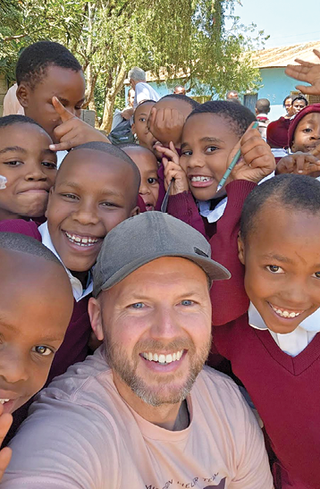 Tanzanian team member Jeff Radichel and school children  