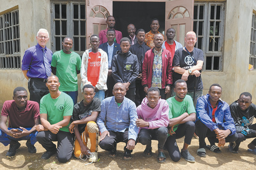 A group of men and women pose for a photo in front of a building.

AI generated content