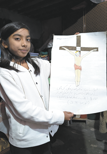 A young girl is holding a picture of a man on a cross.

AI generated content