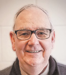 A man wearing glasses and a brown shirt is smiling.

AI generated content