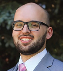 A man wearing a suit and tie is smiling for the camera.

AI generated content