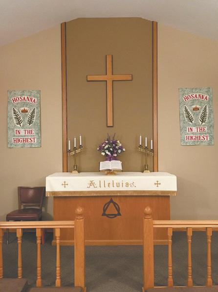 A church with a cross on the wall and a purple flower arrangement.

AI generated content