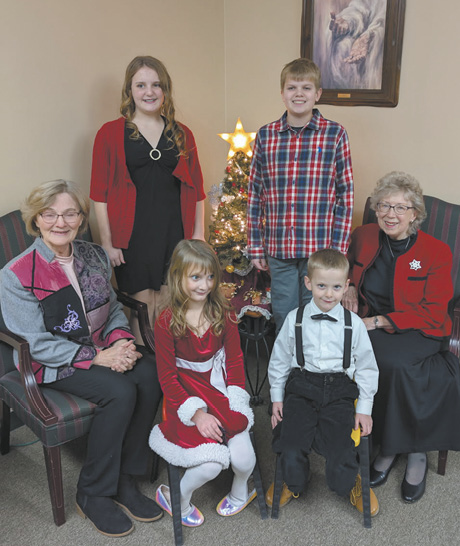 A group of people, including children and adults, pose for a photo in front of a Christmas tree.

AI generated content